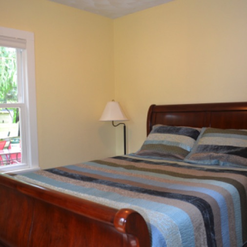 The main level bedroom has a queen bed and a 32 inch TV.